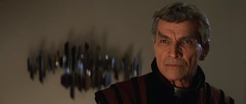 Movie still from “Star Trek III: The Search for Spock” (1984), directed by Leonard Nimoy – An older man in a black and red jacket; Close Up shot, Over the shoulder angle