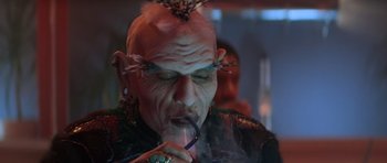 Movie still from “Star Trek III: The Search for Spock” (1984), directed by Leonard Nimoy – An old man with a mohawk smoking a cigarette; Close Up shot, Low angle