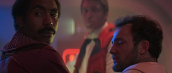 Movie still from “Star Trek III: The Search for Spock” (1984), directed by Leonard Nimoy – A group of men standing next to each other in a room; Close Up shot, Over the shoulder angle