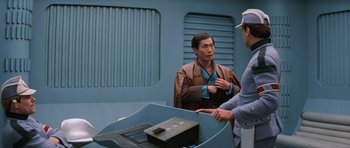 Movie still from “Star Trek III: The Search for Spock” (1984), directed by Leonard Nimoy – Two men standing next to each other in front of a table; Medium shot, Over the shoulder angle