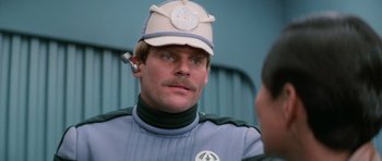 Movie still from “Star Trek III: The Search for Spock” (1984), directed by Leonard Nimoy – A man wearing a hat and a blue jacket; Close Up shot, Over the shoulder angle