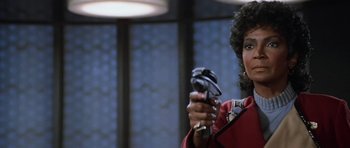 Movie still from “Star Trek III: The Search for Spock” (1984), directed by Leonard Nimoy – A woman holding a video game controller in her hands; Close Up shot, Over the shoulder angle