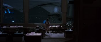 Movie still from “Star Trek III: The Search for Spock” (1984), directed by Leonard Nimoy – A woman standing in front of a table in the dark; Extreme Wide shot, High angle