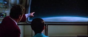 Movie still from “Star Trek III: The Search for Spock” (1984), directed by Leonard Nimoy – A boy points to a picture of the earth from space; Medium shot, Low angle
