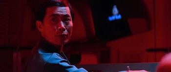 Movie still from “Star Trek III: The Search for Spock” (1984), directed by Leonard Nimoy – A man sitting in front of a tv in a dark room; Close Up shot, Low angle