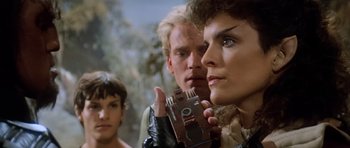 Movie still from “Star Trek III: The Search for Spock” (1984), directed by Leonard Nimoy – A group of people standing next to each other holding a camera; Close Up shot, Over the shoulder angle