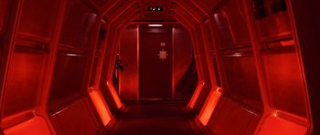 Movie still from “Star Trek III: The Search for Spock” (1984), directed by Leonard Nimoy – A hallway with a red light and a door way; Wide shot, Low angle
