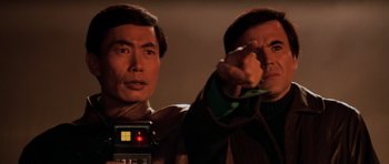 Movie still from “Star Trek III: The Search for Spock” (1984), directed by Leonard Nimoy – Two men are pointing at something in the dark; Close Up shot, Over the shoulder angle