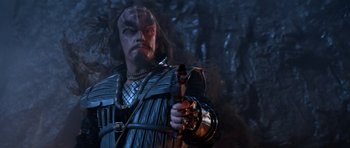 Movie still from “Star Trek III: The Search for Spock” (1984), directed by Leonard Nimoy – A man with a beard holding a gun in his hand; Close Up shot, Over the shoulder angle