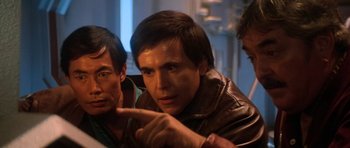 Movie still from “Star Trek III: The Search for Spock” (1984), directed by Leonard Nimoy – A group of men sitting next to each other in a room; Close Up shot, Over the shoulder angle