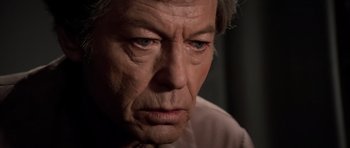 Movie still from “Star Trek III: The Search for Spock” (1984), directed by Leonard Nimoy – An older man with grey hair looking at the camera; Close Up shot, Low angle