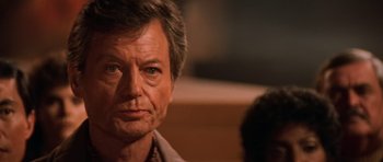 Movie still from “Star Trek III: The Search for Spock” (1984), directed by Leonard Nimoy – A person wearing a suit and tie; Close Up shot, Over the shoulder angle