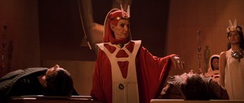 Movie still from “Star Trek III: The Search for Spock” (1984), directed by Leonard Nimoy – An old man dressed in a red and white costume; Medium shot, Over the shoulder angle