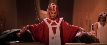 Movie still from “Star Trek III: The Search for Spock” (1984), directed by Leonard Nimoy – A man dressed in a red and white costume; Medium shot, Low angle