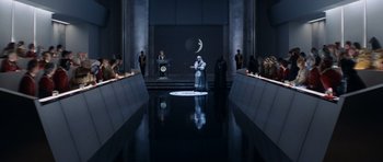 Movie still from “Star Trek IV: The Voyage Home” (1986), directed by Leonard Nimoy – A man standing in front of an audience in front of a screen; Extreme Wide shot, High angle