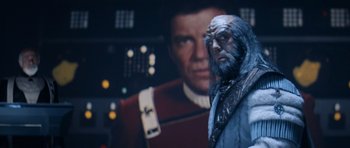 Movie still from “Star Trek IV: The Voyage Home” (1986), directed by Leonard Nimoy – A star trek character in front of a star trek poster; Medium shot, Over the shoulder angle