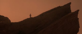 Movie still from “Star Trek IV: The Voyage Home” (1986), directed by Leonard Nimoy – A person standing on top of a hill at sunset; Extreme Wide shot, Low angle
