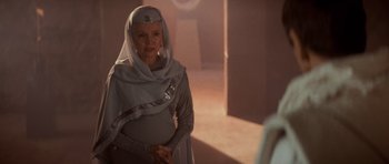 Movie still from “Star Trek IV: The Voyage Home” (1986), directed by Leonard Nimoy – An older woman wearing a gray outfit and a white headscarf; Medium shot, Over the shoulder angle