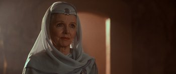 Movie still from “Star Trek IV: The Voyage Home” (1986), directed by Leonard Nimoy – An older woman wearing a headdress and a scarf; Close Up shot, Over the shoulder angle