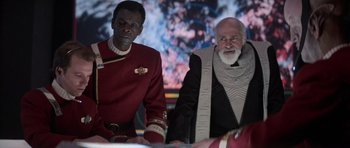 Movie still from “Star Trek IV: The Voyage Home” (1986), directed by Leonard Nimoy – Two men dressed in star trek uniforms are sitting next to each other in front of a screen; Medium shot, Over the shoulder angle