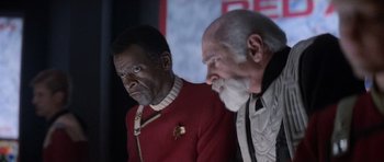 Movie still from “Star Trek IV: The Voyage Home” (1986), directed by Leonard Nimoy – Two men dressed in star trek uniforms looking at each other; Close Up shot, Over the shoulder angle