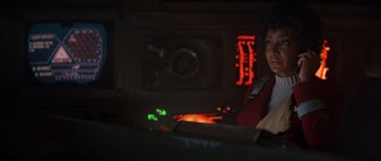 Movie still from “Star Trek IV: The Voyage Home” (1986), directed by Leonard Nimoy – A woman is sitting in front of an oven in the dark; Close Up shot, Over the shoulder angle