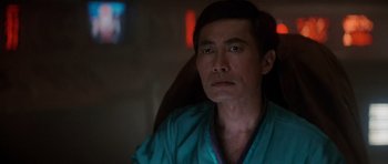 Movie still from “Star Trek IV: The Voyage Home” (1986), directed by Leonard Nimoy – A man sitting in front of a window looking into the distance; Close Up shot, Low angle