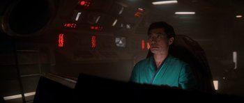 Movie still from “Star Trek IV: The Voyage Home” (1986), directed by Leonard Nimoy – A man wearing a green robe in a dark room; Medium shot, Low angle