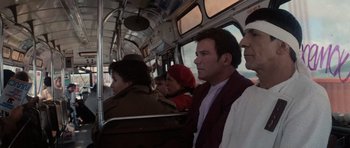 Movie still from “Star Trek IV: The Voyage Home” (1986), directed by Leonard Nimoy – A group of people riding on a bus together; Medium shot, Over the shoulder angle