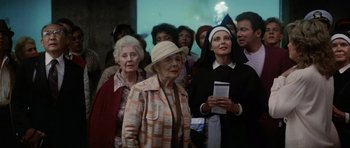 Movie still from “Star Trek IV: The Voyage Home” (1986), directed by Leonard Nimoy – A group of people standing in front of a building; Medium shot, Low angle