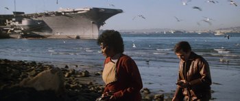 Movie still from “Star Trek IV: The Voyage Home” (1986), directed by Leonard Nimoy – A woman standing on a beach near the water; Extreme Wide shot, Low angle