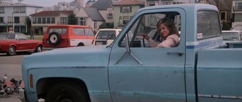 Movie still from “Star Trek IV: The Voyage Home” (1986), directed by Leonard Nimoy – A woman sitting in the driver's seat of an old truck; Wide shot, Over the shoulder angle