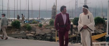Movie still from “Star Trek IV: The Voyage Home” (1986), directed by Leonard Nimoy – A man in a red suit standing on the side of a road; Wide shot, Low angle