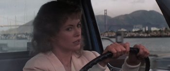 Movie still from “Star Trek IV: The Voyage Home” (1986), directed by Leonard Nimoy – A woman driving a car with the golden gate bridge in the background; Close Up shot, Over the shoulder angle