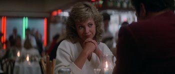 Movie still from “Star Trek IV: The Voyage Home” (1986), directed by Leonard Nimoy – A woman sitting at a dinner table with her hand under her chin; Close Up shot, Over the shoulder angle