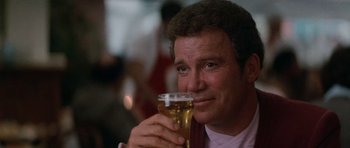 Movie still from “Star Trek IV: The Voyage Home” (1986), directed by Leonard Nimoy – A person holding a glass of beer; Close Up shot, Over the shoulder angle
