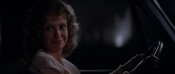 Movie still from “Star Trek IV: The Voyage Home” (1986), directed by Leonard Nimoy – A person with curly blonde hair; Close Up shot, Over the shoulder angle