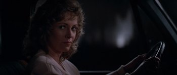 Movie still from “Star Trek IV: The Voyage Home” (1986), directed by Leonard Nimoy – A person sitting in a car at night; Close Up shot, Over the shoulder angle