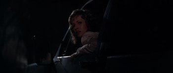 Movie still from “Star Trek IV: The Voyage Home” (1986), directed by Leonard Nimoy – A woman sitting in a chair in a dark room; Medium shot, Low angle