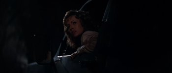 Movie still from “Star Trek IV: The Voyage Home” (1986), directed by Leonard Nimoy – A woman sitting in a chair in a dark room; Medium shot, Low angle