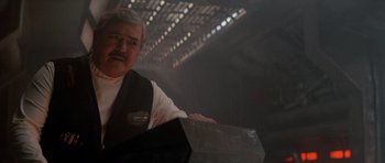 Movie still from “Star Trek IV: The Voyage Home” (1986), directed by Leonard Nimoy – An older man holding a box in front of a building; Close Up shot, Over the shoulder angle