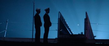 Movie still from “Star Trek IV: The Voyage Home” (1986), directed by Leonard Nimoy – Two men in uniform standing next to each other on a bridge; Wide shot, Low angle