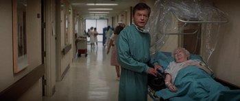 Movie still from “Star Trek IV: The Voyage Home” (1986), directed by Leonard Nimoy – A man in a surgical gown standing in a hospital hallway; Medium shot, Over the shoulder angle