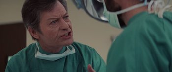 Movie still from “Star Trek IV: The Voyage Home” (1986), directed by Leonard Nimoy – A man in a green gown talking to another man in a green gown; Close Up shot, Over the shoulder angle