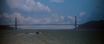 Movie still from “Star Trek IV: The Voyage Home” (1986), directed by Leonard Nimoy – A boat floating on top of a body of water near a bridge; Extreme Wide shot, Low angle