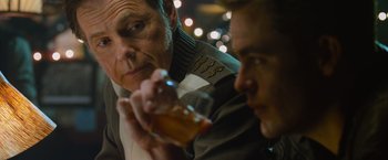 Movie still from “Star Trek Into Darkness” (2013), directed by J.J. Abrams – A man drinking a glass of beer next to another man; Close Up shot, Over the shoulder angle