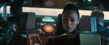 Movie still from “Star Trek Into Darkness” (2013), directed by J.J. Abrams – A woman sitting in a chair reading a book; Close Up shot, Over the shoulder angle