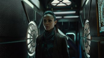 Movie still from “Star Trek Into Darkness” (2013), directed by J.J. Abrams – A woman standing in front of a clock; Close Up shot, Over the shoulder angle
