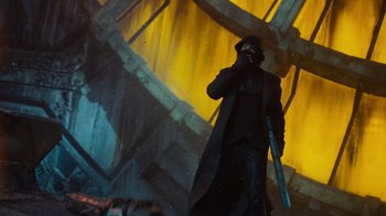 Movie still from “Star Trek Into Darkness” (2013), directed by J.J. Abrams – A man in a trench coat and hat holding a gun; Wide shot, Low angle