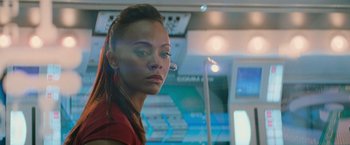 Movie still from “Star Trek Into Darkness” (2013), directed by J.J. Abrams – A woman in a red shirt is standing in front of a mirror; Close Up shot, Over the shoulder angle